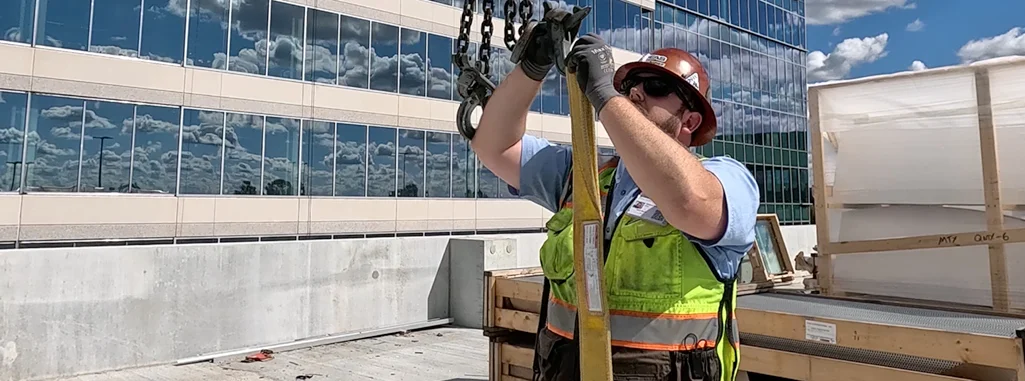 Southeastern Architectural Systems installer using lifting equipment on a commercial building project